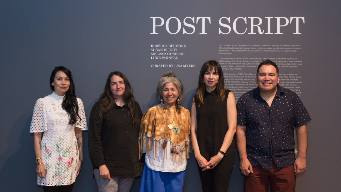 Susan Blight, Lisa Myers, Mary Anne Caibaiosai, Melissa General and Luke Parnell stand together in front of the title wall for Post Script